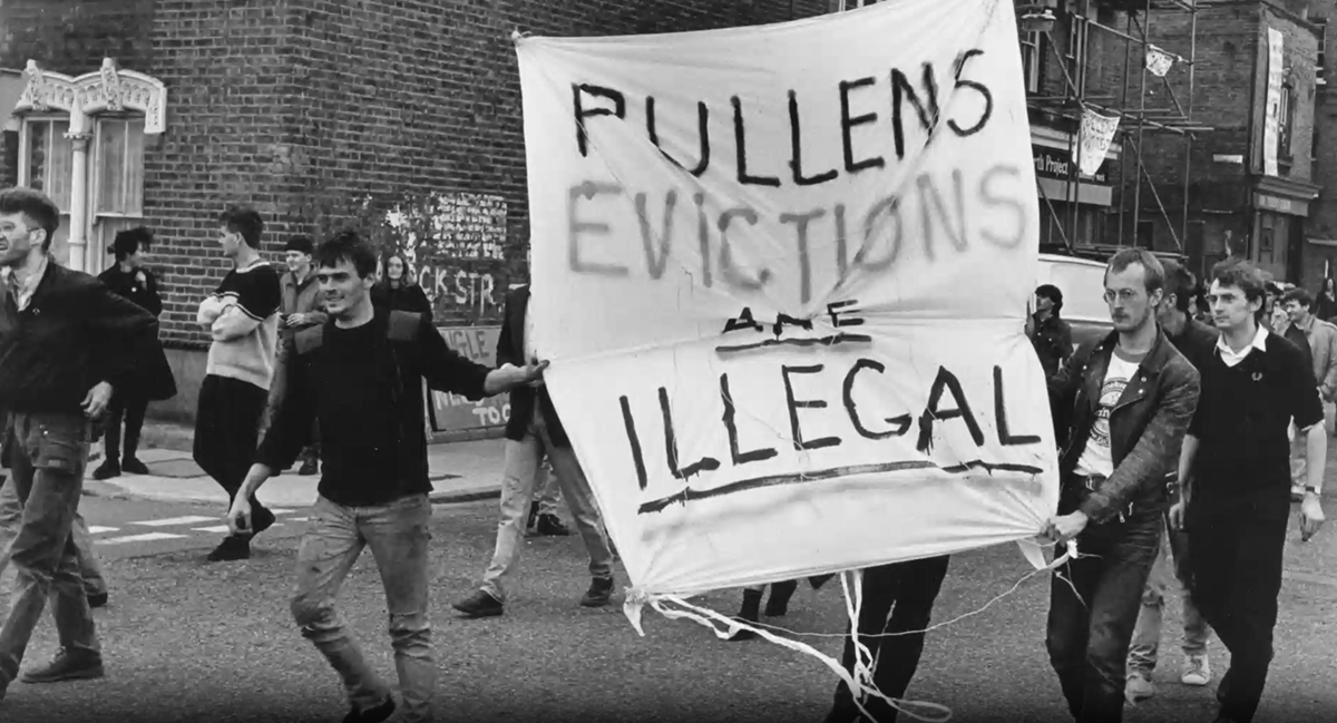 article thumb - Screen shot from the film Pullenites showing activists and residents marching with banners