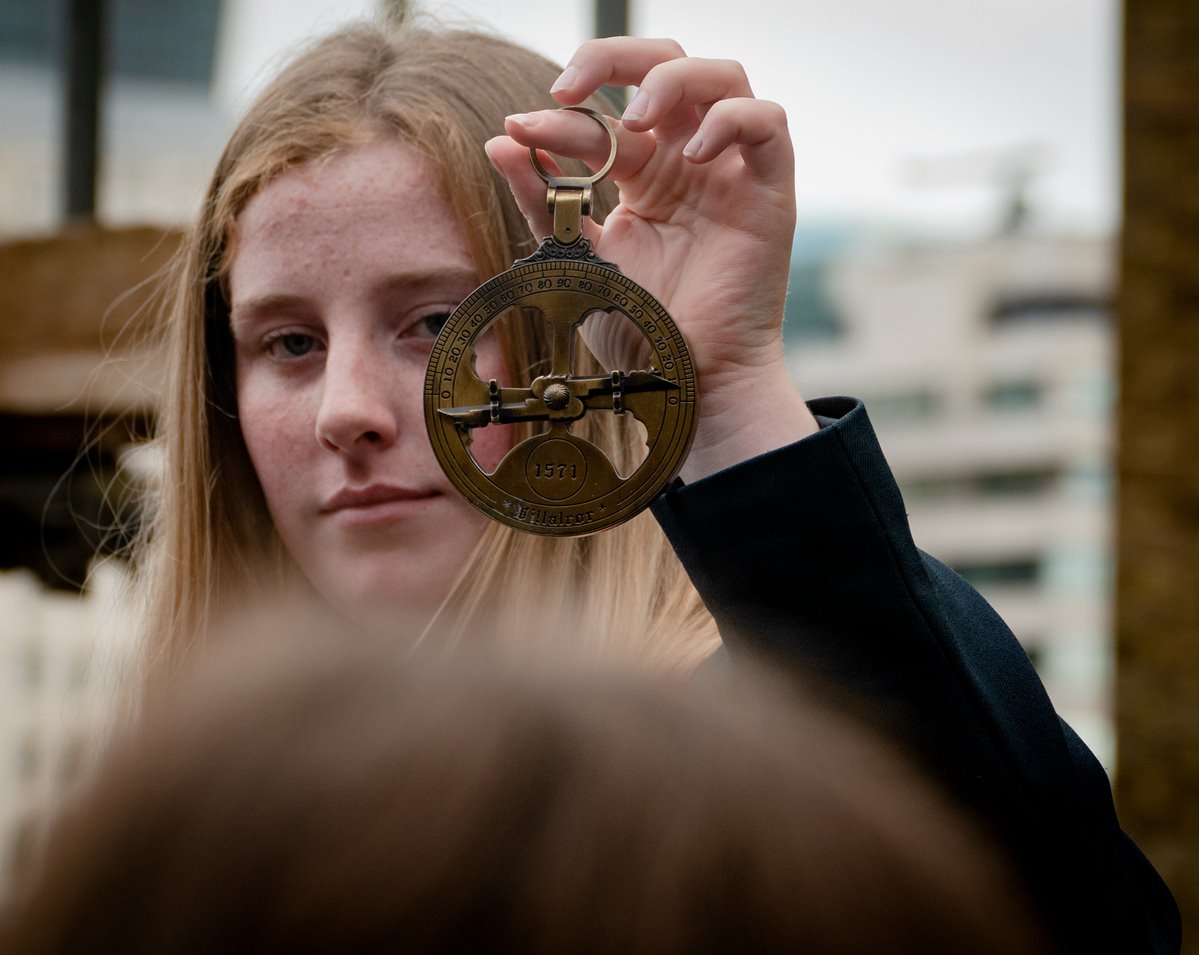 article thumb - Girl holding a astrolabe