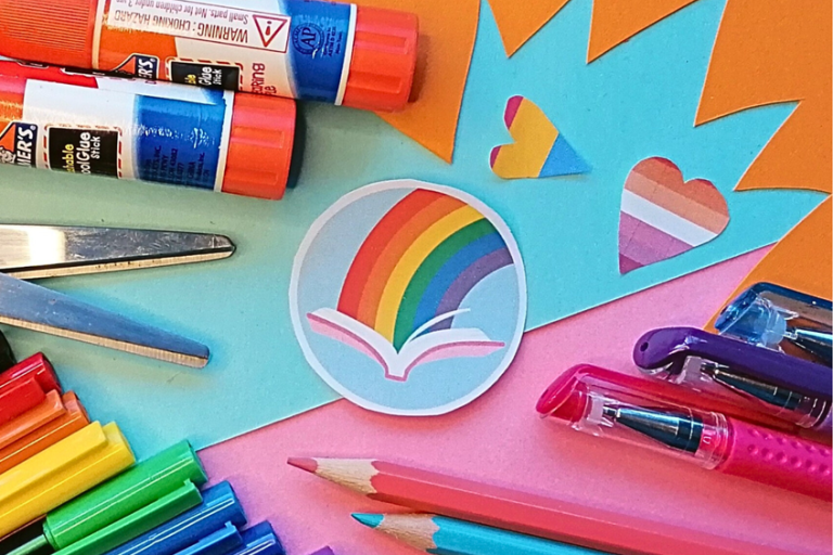 Crafting and art materials on a bright orange and pink background