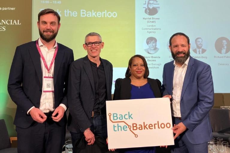Leader of Southwark Council Cllr Kieron Williams, Mayor of Lewisham Brenda Dacres, as well as Patrick Doig the Group Finance Director from TfL, Harriet Shone Director of London Communications Agency and Richard Palmer the Development Director from Delancey hold "Back the Bakerloo" placard.