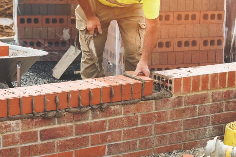 Bricks being laid as part of council home construction