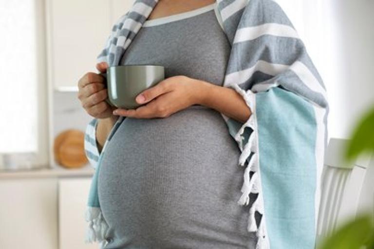 Pregnant woman holding cup