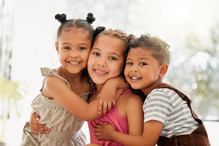 Three children hugging