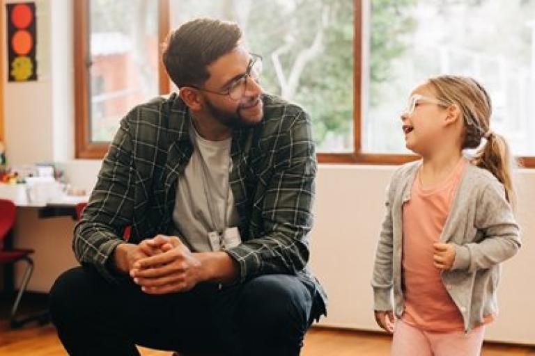 A man and a young girl talking
