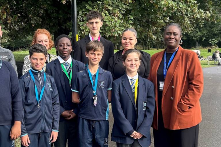 Group of school children and teachers with Councillor Ennin in Burgess Park