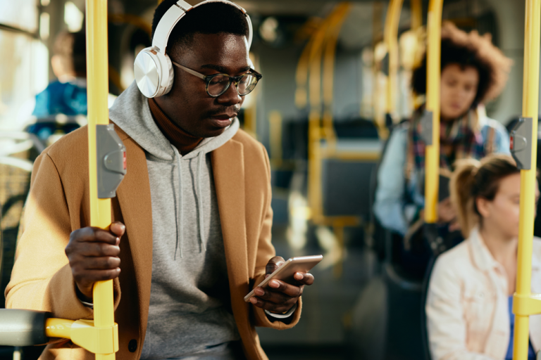 Young man with headphones using smart phone