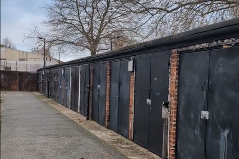 A row of garages in Scylla Road site for planned new affordable housing