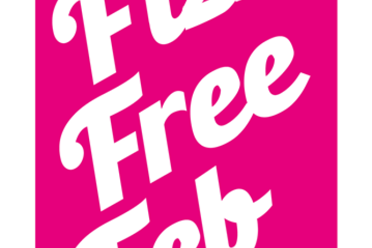 A bright pink drink can with Fizz Free February written on the side