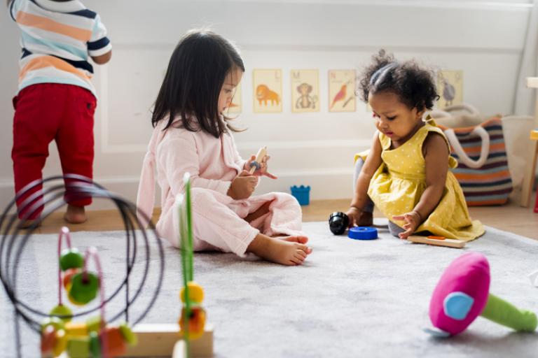 Two young children playing in a playgroup