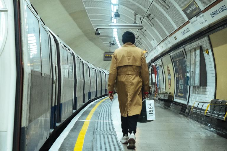 A woman walks down the platform at Elephant & Castle tube station