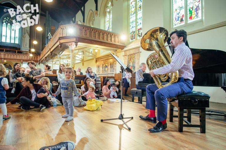 bach to baby audience watches a tuba player
