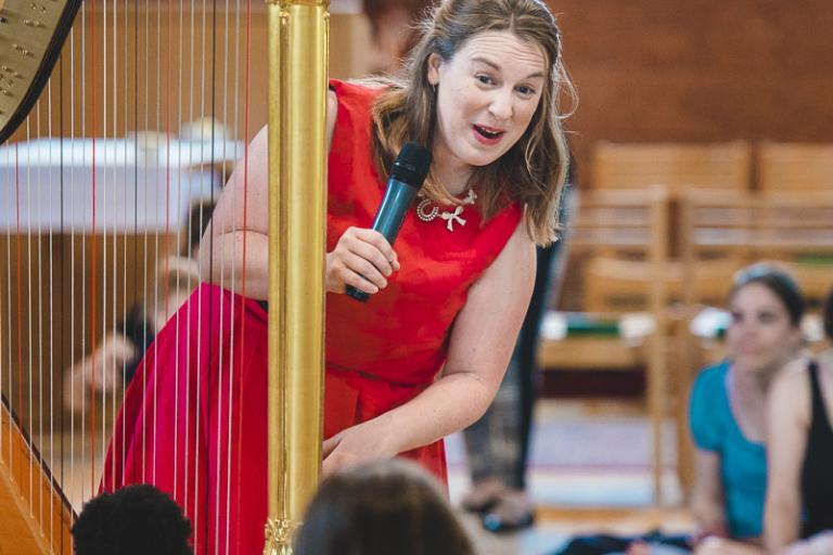 harpist interacts with children at bach to baby concert