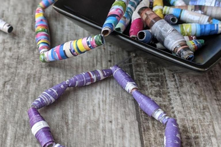 paper beads bracelets inside a small black square bowl