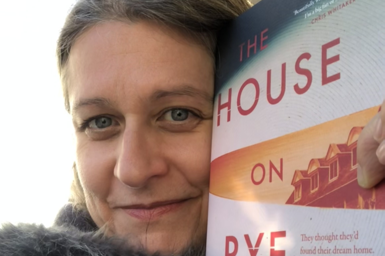 Picture of author Susan Allott with a copy of her book 'The House on Rye Lane'