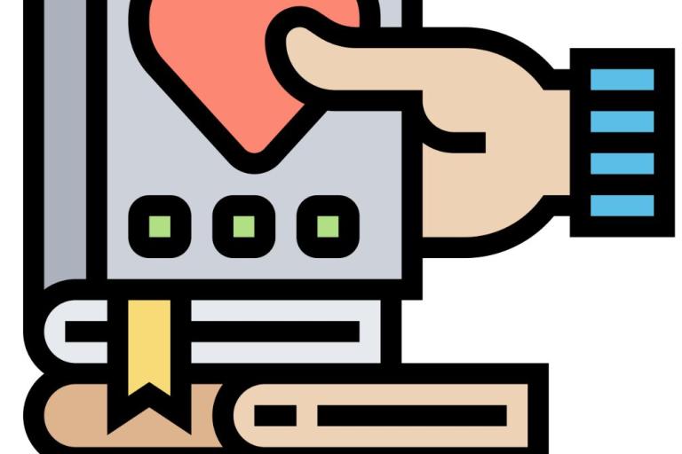 hand holding book with heart