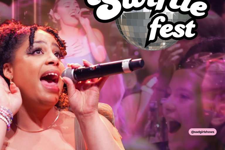 A woman sings into a microphone, in the back ground a young girl gasps in excitement 