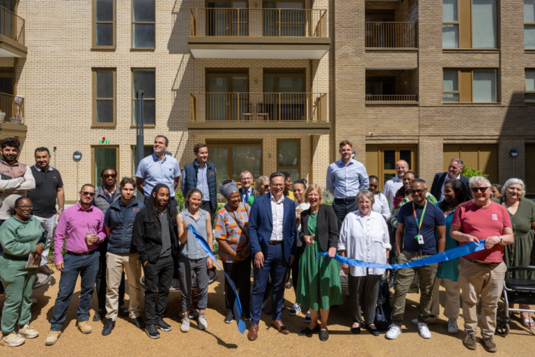 Photo of ribbon cutting ceremony with residents and Councillors outside of Aylesbury Estate