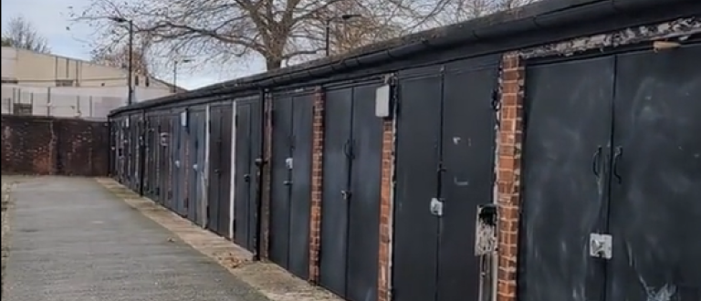 A row of garages on Scylla Road site for planned new affordable housing