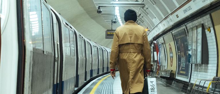 A woman walks down the platform at Elephant & Castle tube station