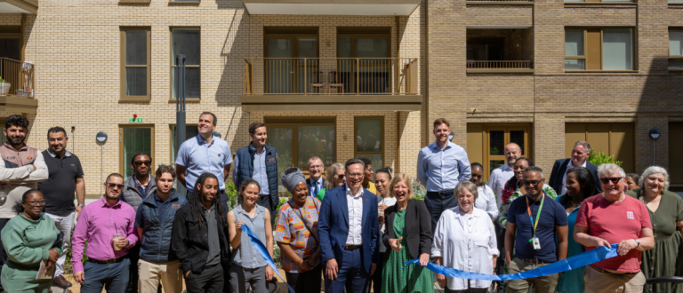 Photo of ribbon cutting ceremony with residents and Councillors outside of Aylesbury Estate