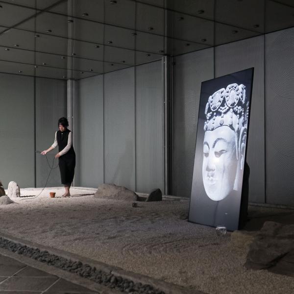 A person stands in an art installation.