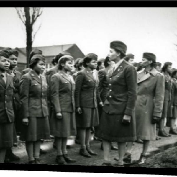 A group of women in uniform in line having an inspection