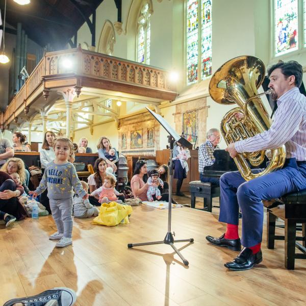 bach to baby audience watches a tuba player