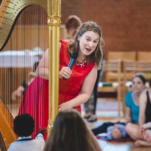 harpist interacts with children at bach to baby concert