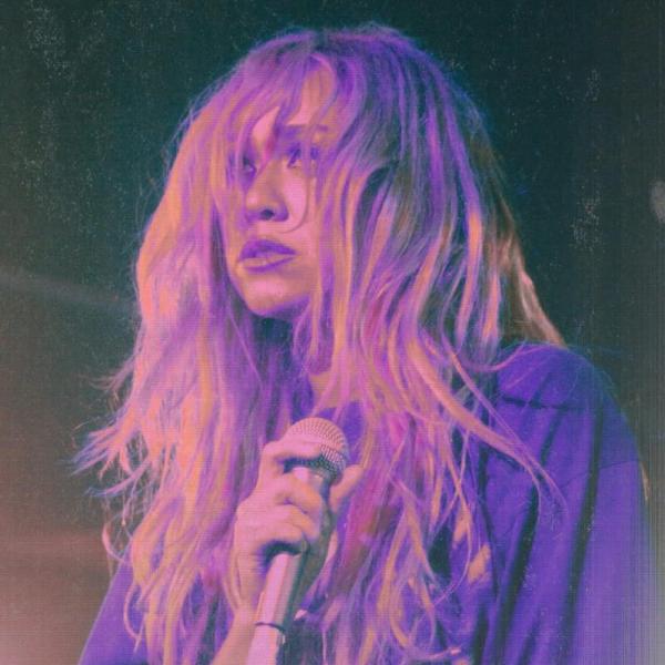 A close up of the artist Jeanie Crystal performing.