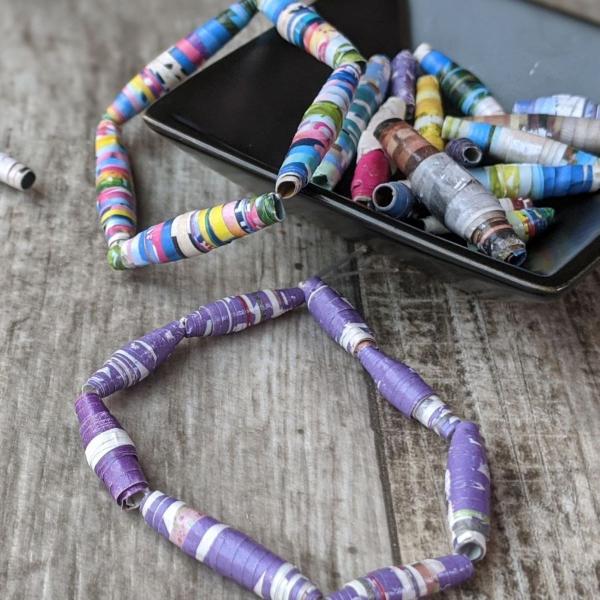 paper beads bracelets inside a small black square bowl