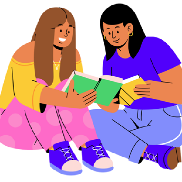 Two women reading a book together