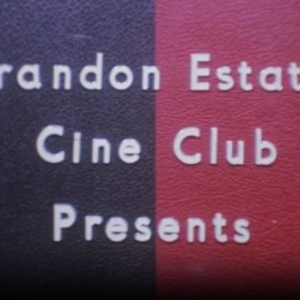 Screenshot of an intertitle reading 'Brandon Estate Cine Club Presents' from the film Return to Canvey Island (1972). White letters on dark blue and maroon coloured background.
